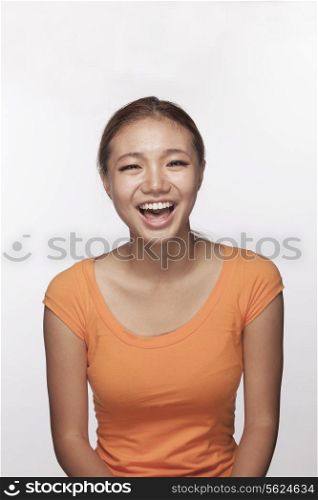 Portrait of teenage girl smiling, studio shot
