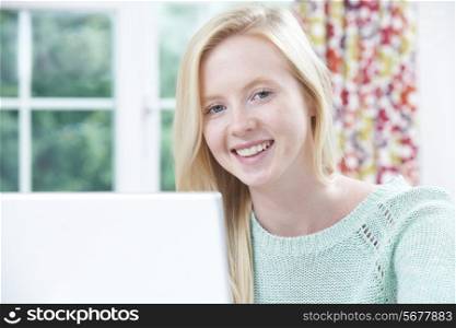 Portrait Of Teenage Girl Using Computer At Home