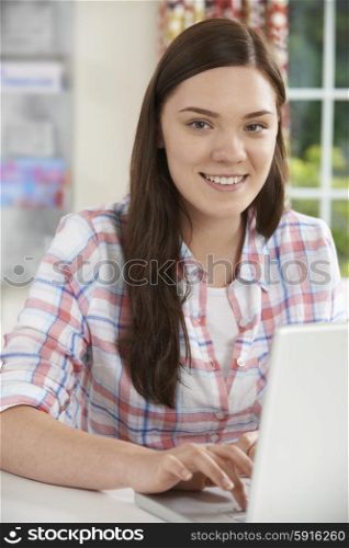 Portrait Of Teenage Girl Using Laptop At Home