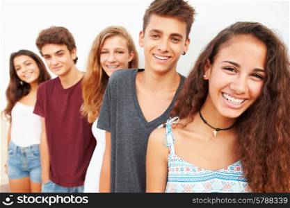 Portrait Of Teenage Group Leaning Against Wall