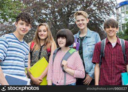 Portrait Of Teenage Students Outside School Building