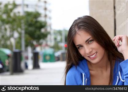 Portrait of teenager sitting in the street
