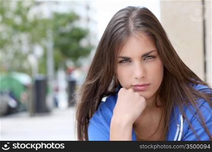 Portrait of teenager sitting in the street