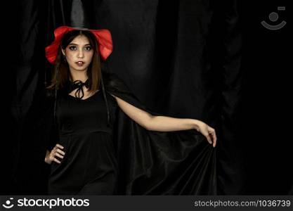 Portrait of teenager young adult girl in Halloween costume for Halloween party background