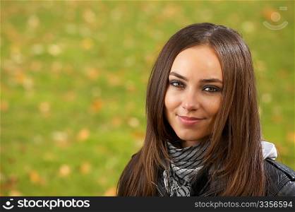 Portrait of the attractive girl against a lawn