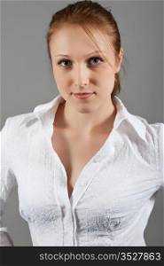 Portrait of the beautiful girl in a white blouse