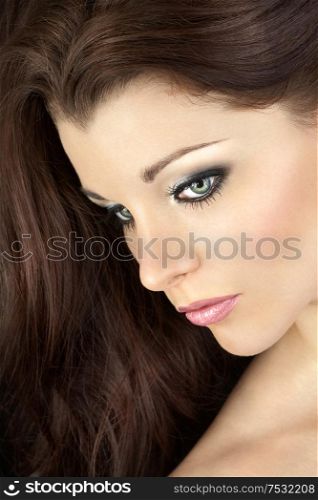 Portrait of the beautiful girl on a black background