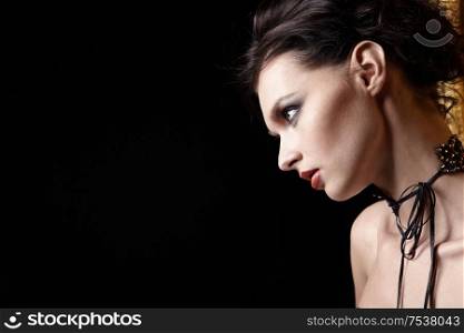 Portrait of the beautiful girl on a black background