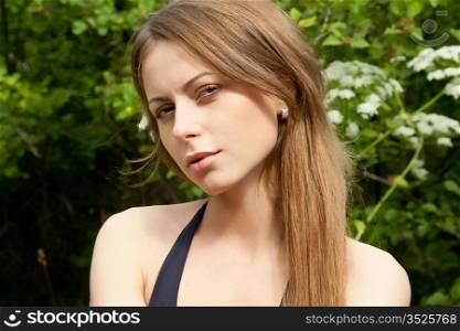 Portrait of the beautiful girl on the nature