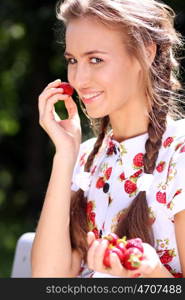 Portrait of the beautiful girl with a strawberry