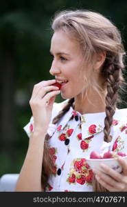 Portrait of the beautiful girl with a strawberry