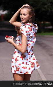 Portrait of the beautiful girl with a strawberry