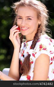 Portrait of the beautiful girl with a strawberry