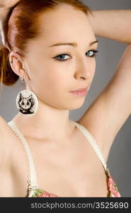 Portrait of the beautiful red-haired girl in elegant linen