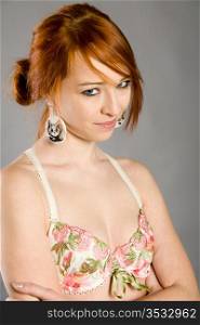 Portrait of the beautiful red-haired girl in elegant linen