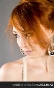 Portrait of the beautiful red-haired girl in elegant linen