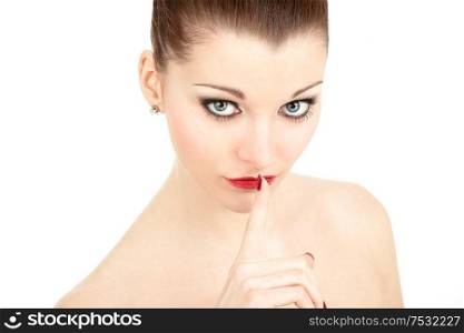 Portrait of the beautiful woman with a finger at the lips, isolated