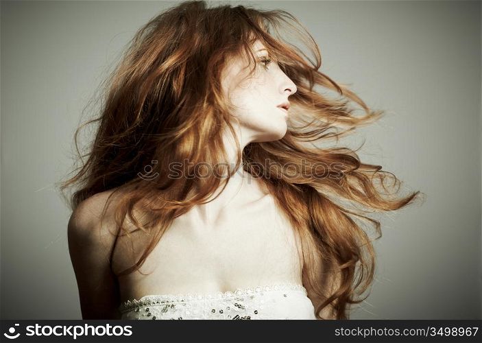 Portrait of the beautiful woman with red curly hair
