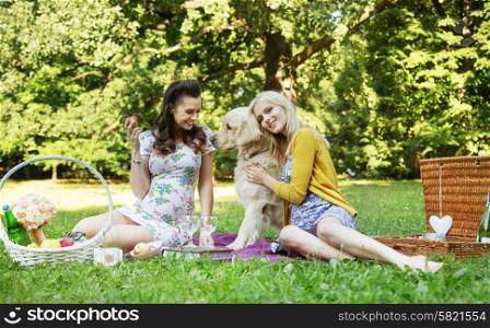 Portrait of the cheerful girlfriends hugging friendly dog
