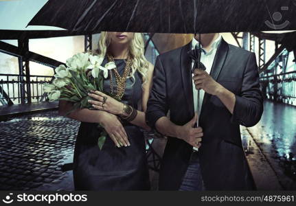 Portrait of the couple standing in the heavy rain