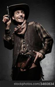 Portrait of the cowboy closeup. The smiling cowboy with pistols closeup