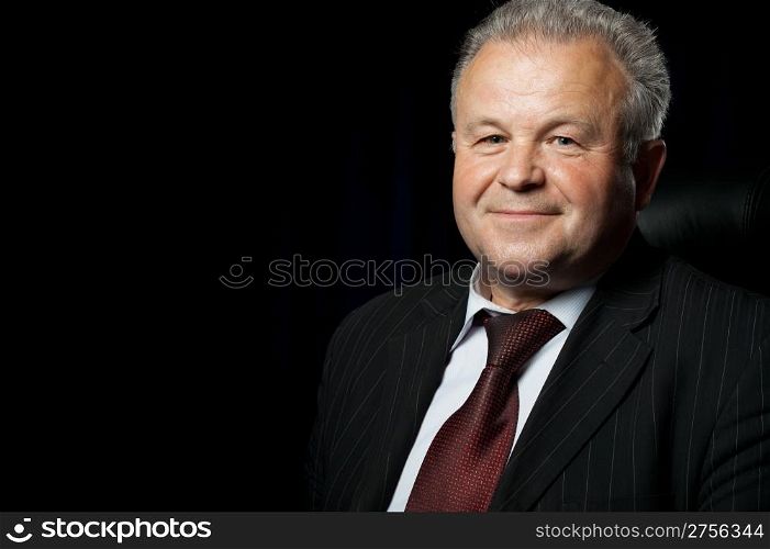 Portrait of the elderly man. A photo against a dark background