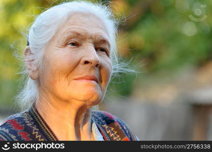 Portrait of the elderly woman. A photo on outdoors