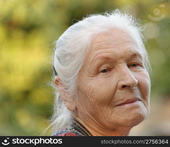 Portrait of the elderly woman. A photo on outdoors