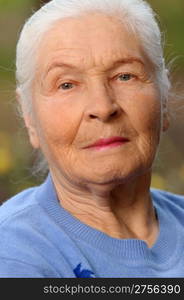 Portrait of the elderly woman. A photo on outdoors