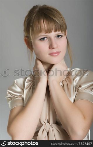 Portrait of the girl in a beautiful dress on a gray background