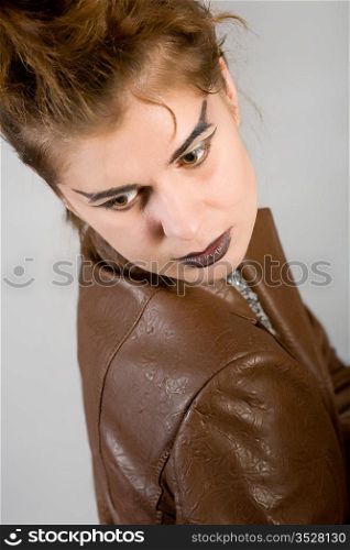 Portrait of the girl in a brown leather jacket