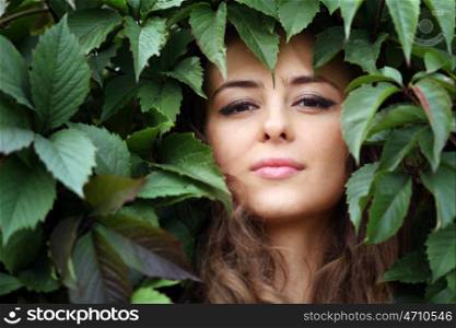 Portrait of the girl in green foliage