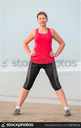 Portrait of the girl in sportswear on the beach