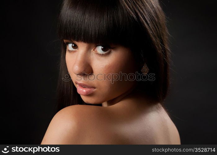 Portrait of the girl on a black background