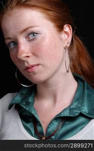 Portrait of the girl with freckles and red hair