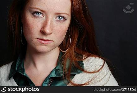 Portrait of the girl with freckles and red hair