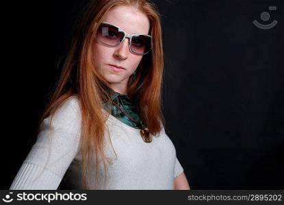 Portrait of the girl with sunglasses on dark