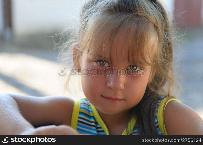 Portrait of the little girl close up. Outdoors