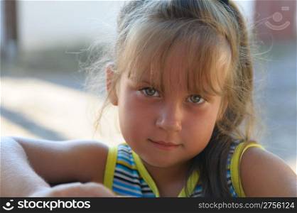 Portrait of the little girl close up. Outdoors