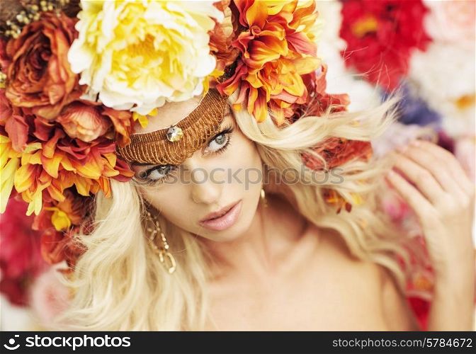 Portrait of the serious blonde wearing huge colorful wreath