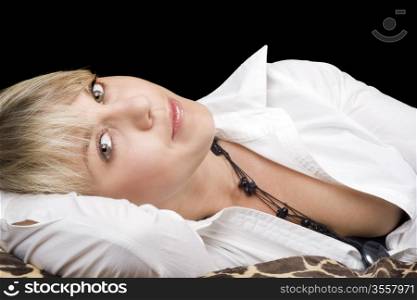portrait of the sexy young beauty blonde lies on a bed. Isolated