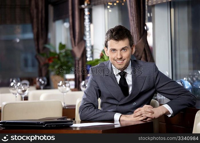 Portrait of the smiling business man at restaurant