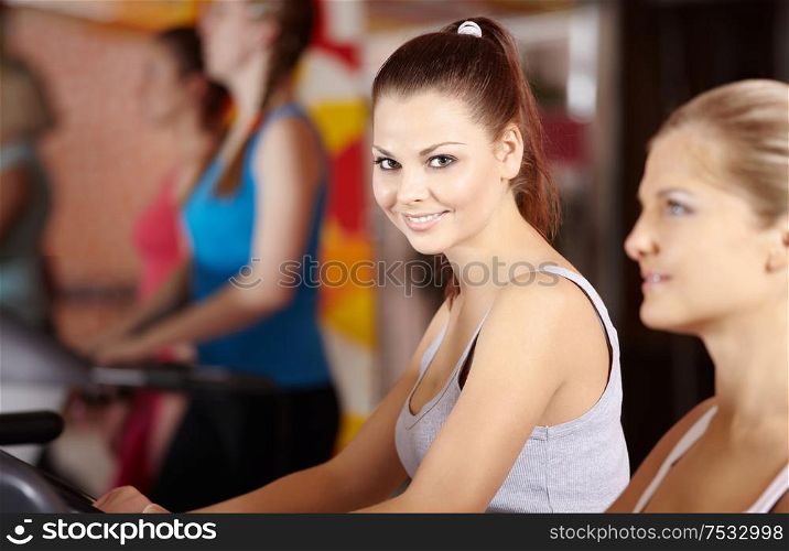 Portrait of the smiling training girl on a racetrack