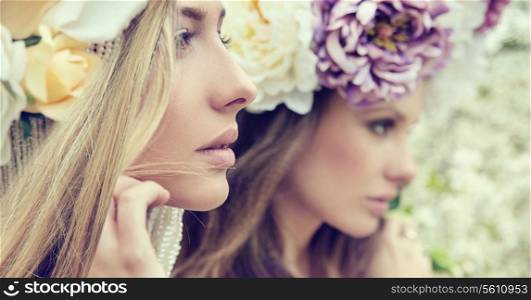 Portrait of the two gorgeous ladies with wild flowers