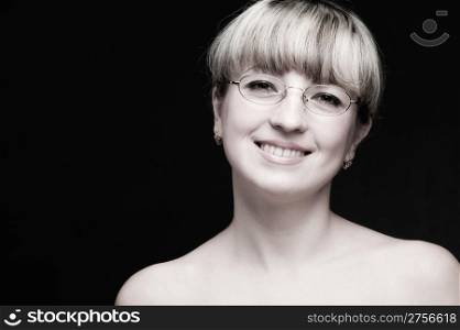 Portrait of the woman in eyeglasses close up. The bared shoulders. Toned image.