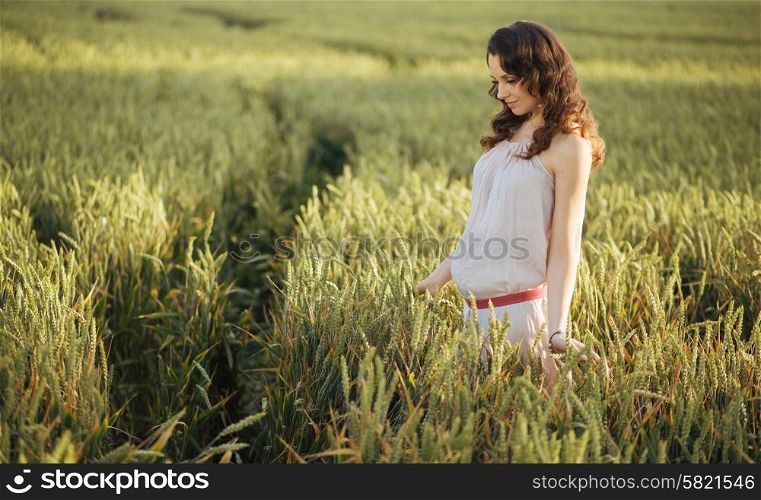 Portrait of the woman on the fresh cereal field