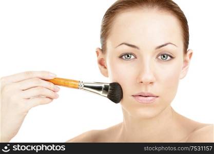 Portrait of the woman putting on a cheek a brush, isolated
