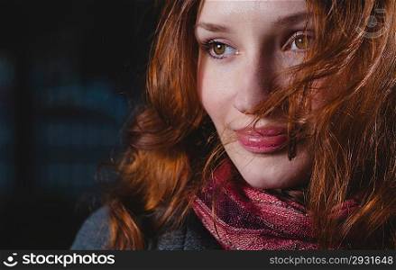Portrait of the young 20s redhead women in autumn park. Very closeup shot, model looking away
