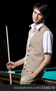 Portrait of the young attractive man with cue