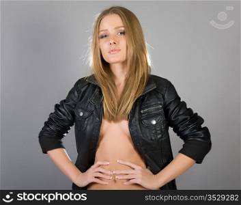 Portrait of the young beautiful girl in a leather jacket